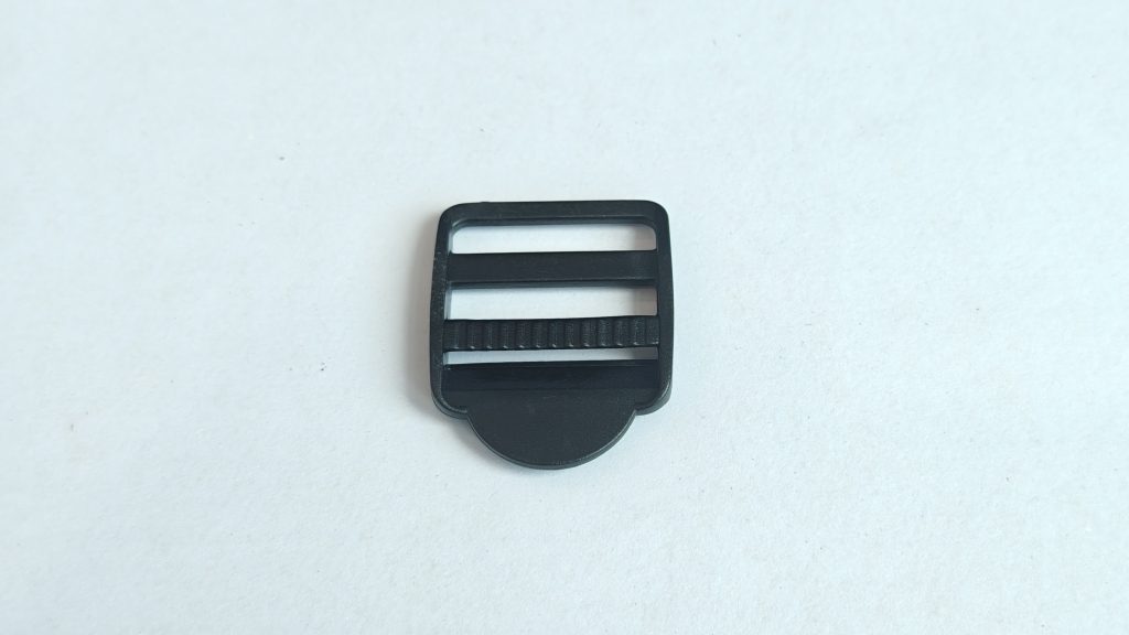 Tri-glide buckle with rounded-corner frame and raised-pattern crossbar pull tab, product photo 1